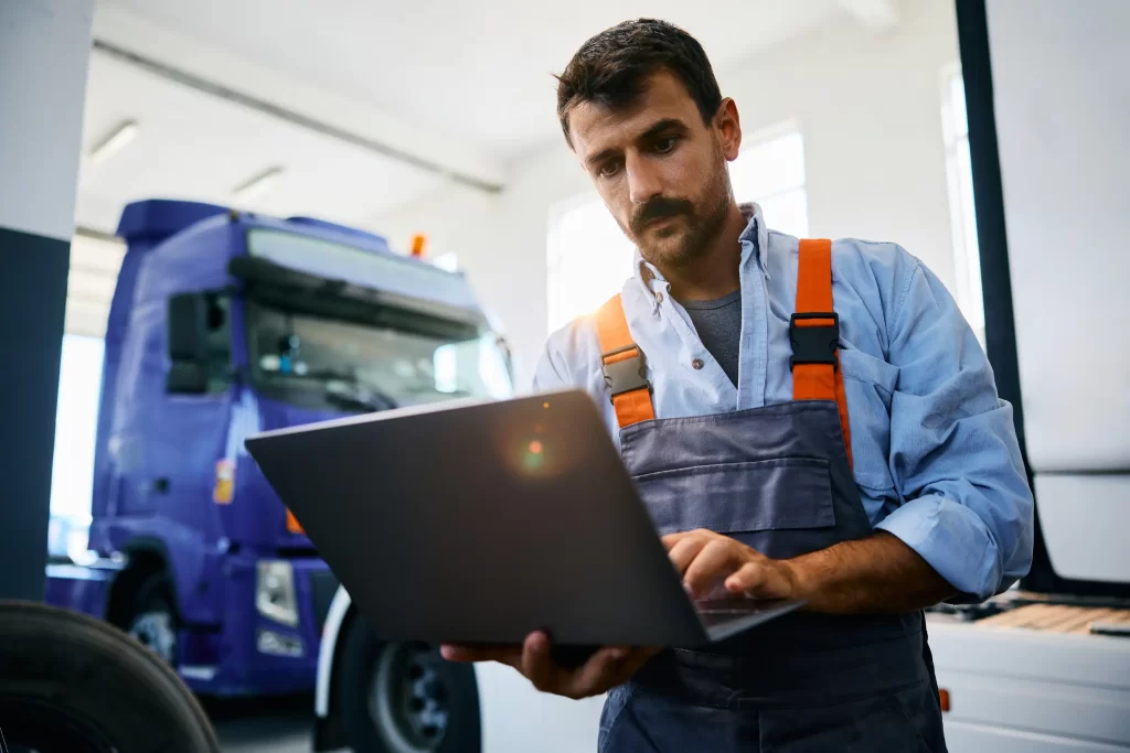 A mechanic conducting a comprehensive truck maintenance check to prevent jumpstarts.