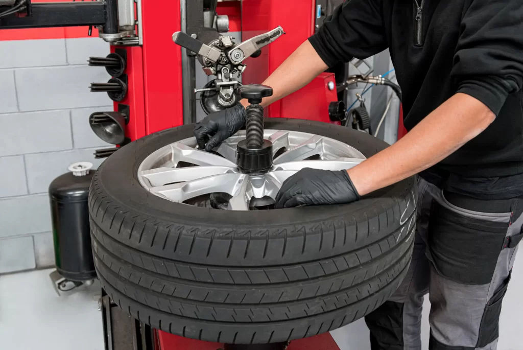 A mechanic dismantling the tire in an equipment.