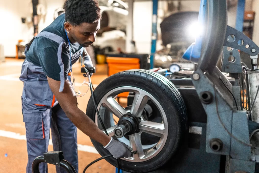 A professional technician doing a repair to a tire in the shop.