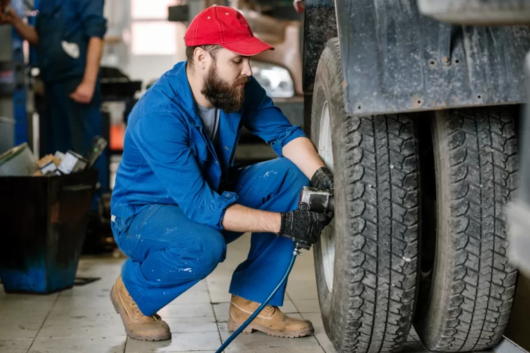 A mechanic performing ruck tire repair to prevent costly damage.