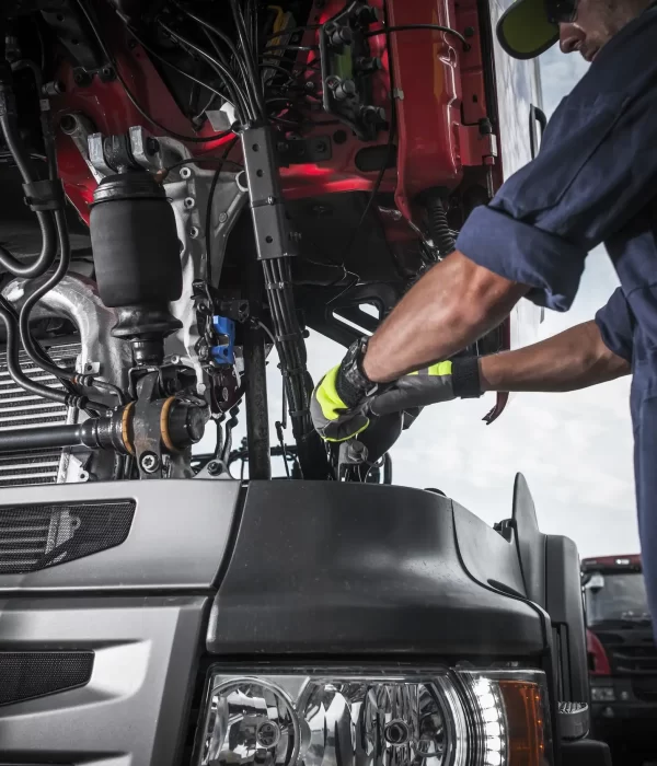 A mechanic repairing the wires and system of a trailer truck 2