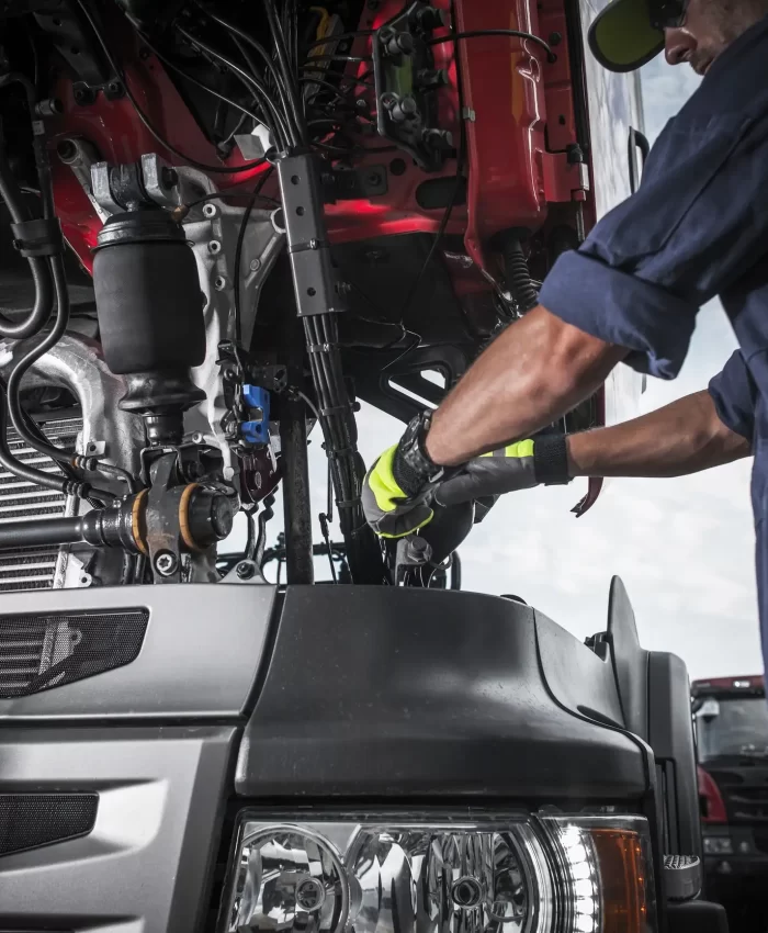 A mechanic repairing the wires and system of a trailer truck 2